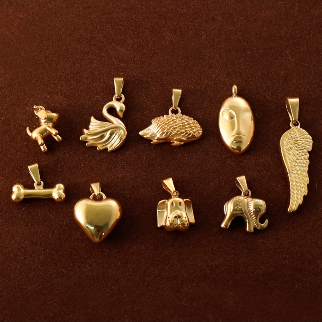 Gold animal and symbol pendants: swan, hedgehog, heart, dog, elephant, angel wing, face, bone — trendy charms for necklaces