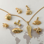 Gold animal charm pendants and necklaces, including heart, swan, hedgehog, and elephant designs for women’s jewelry.