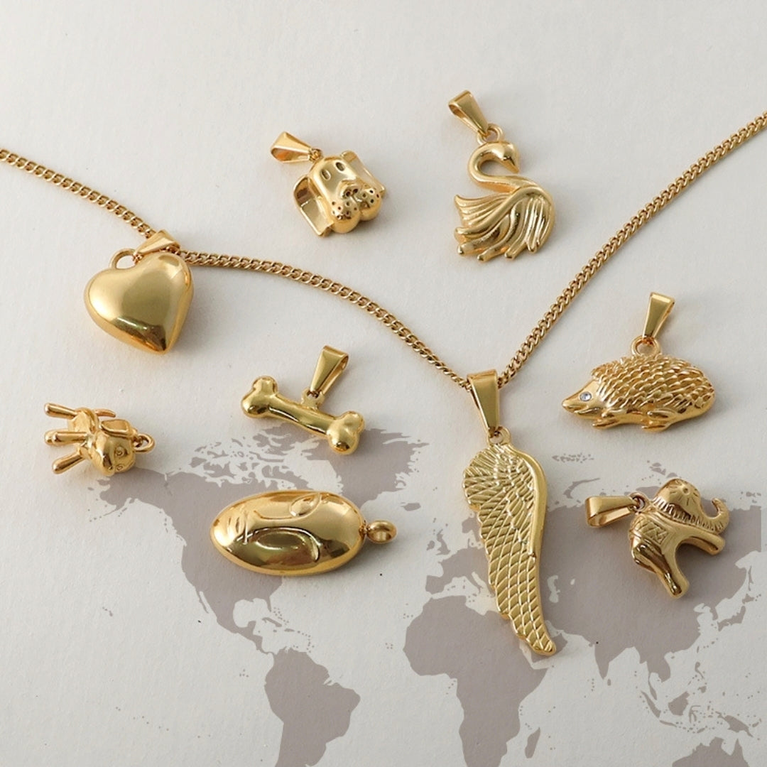 Gold animal charm pendants and necklaces, including heart, swan, hedgehog, and elephant designs for women’s jewelry.