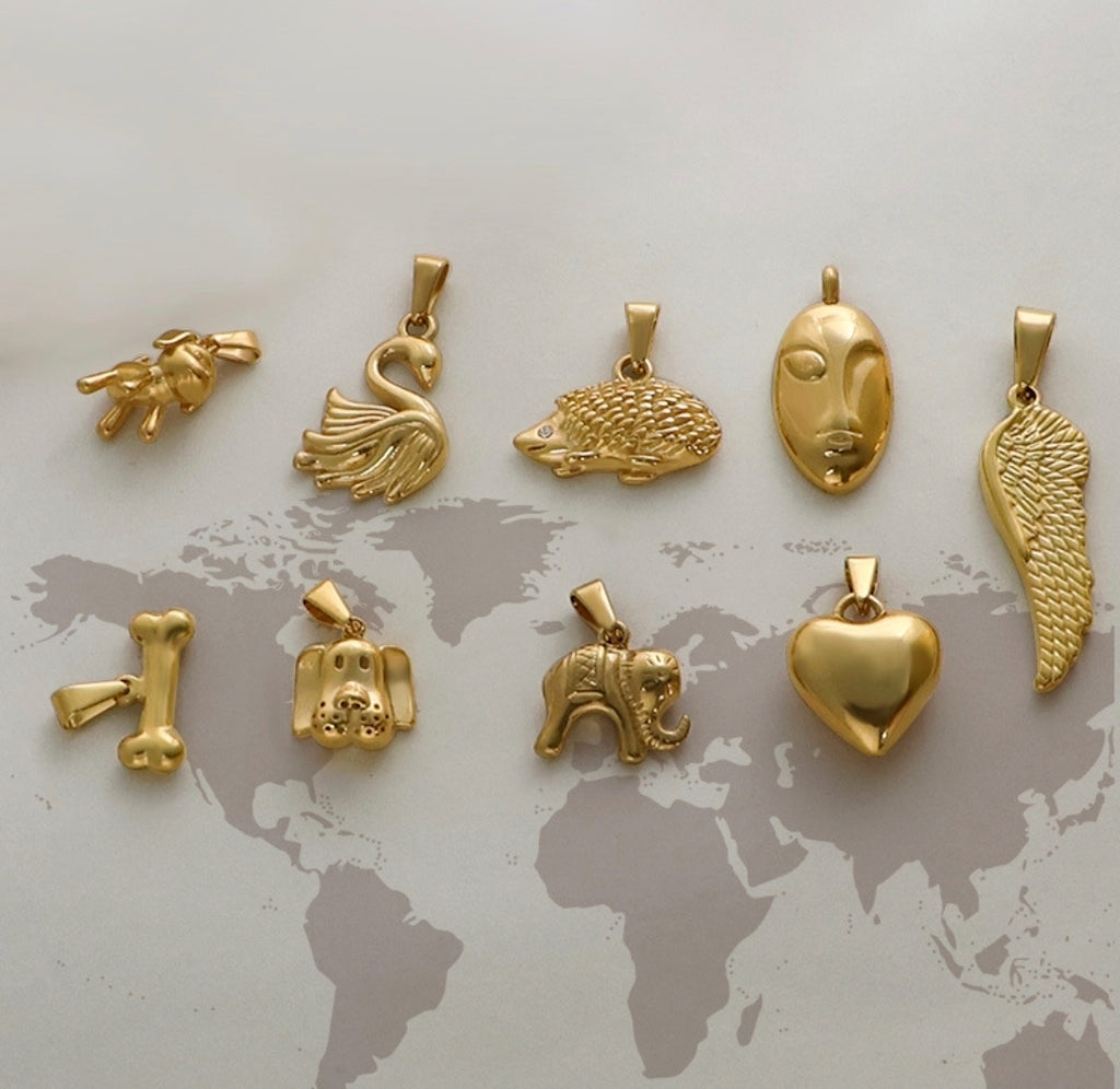 Gold animal and symbol charms: swan, hedgehog, face, wing, heart, elephant, dog, bone — trendy jewelry pendants