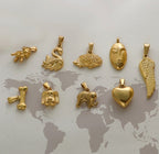 Gold animal and symbol charms: swan, hedgehog, face, wing, heart, elephant, dog, bone — trendy jewelry pendants