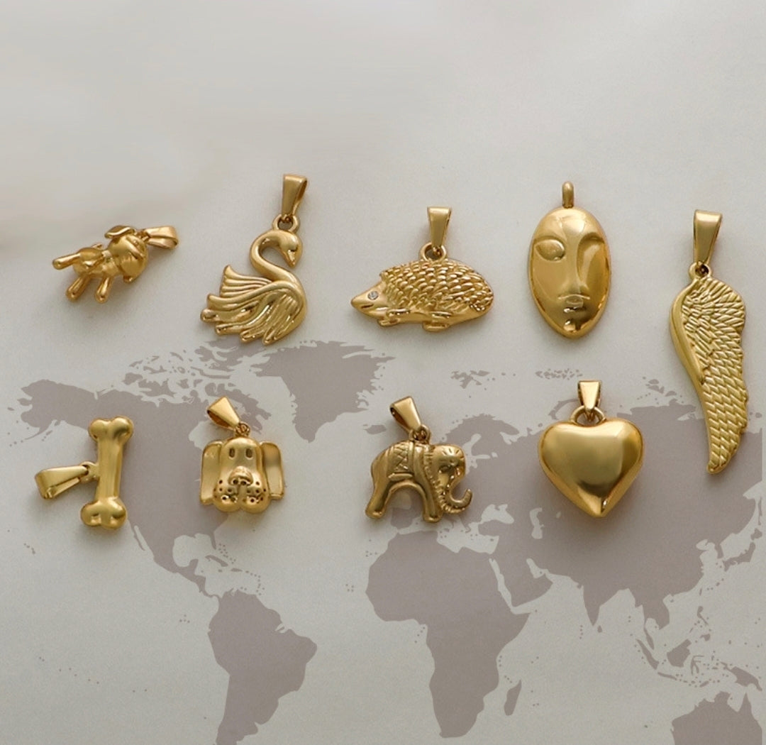 Gold animal and symbol charms: swan, hedgehog, face, wing, heart, elephant, dog, bone — trendy jewelry pendants